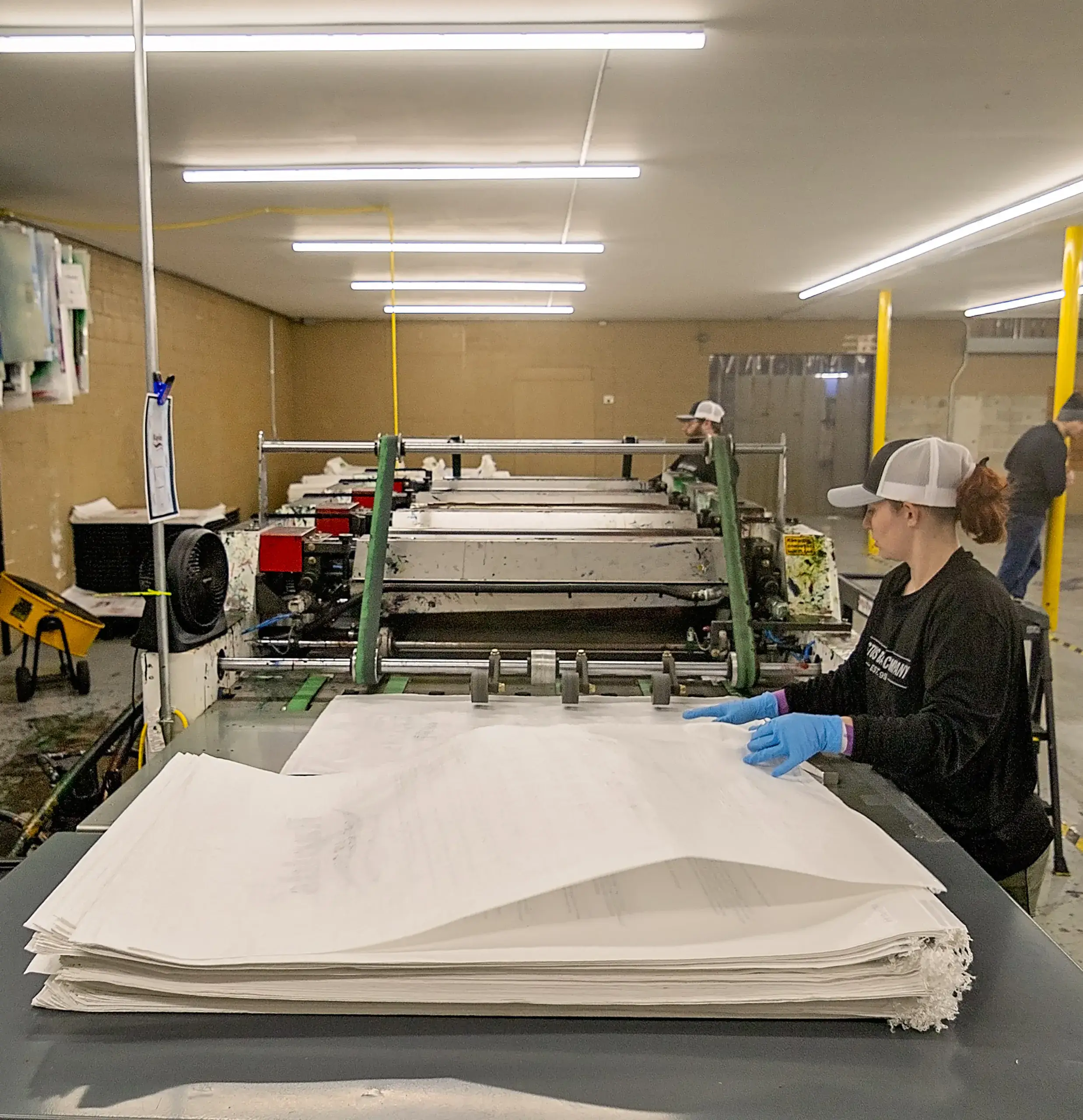 A woman working on printing bags